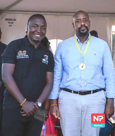 Moses Gumisiriza poses for a photo with Gen MK at one of the PLU's functions which he was emceeing 